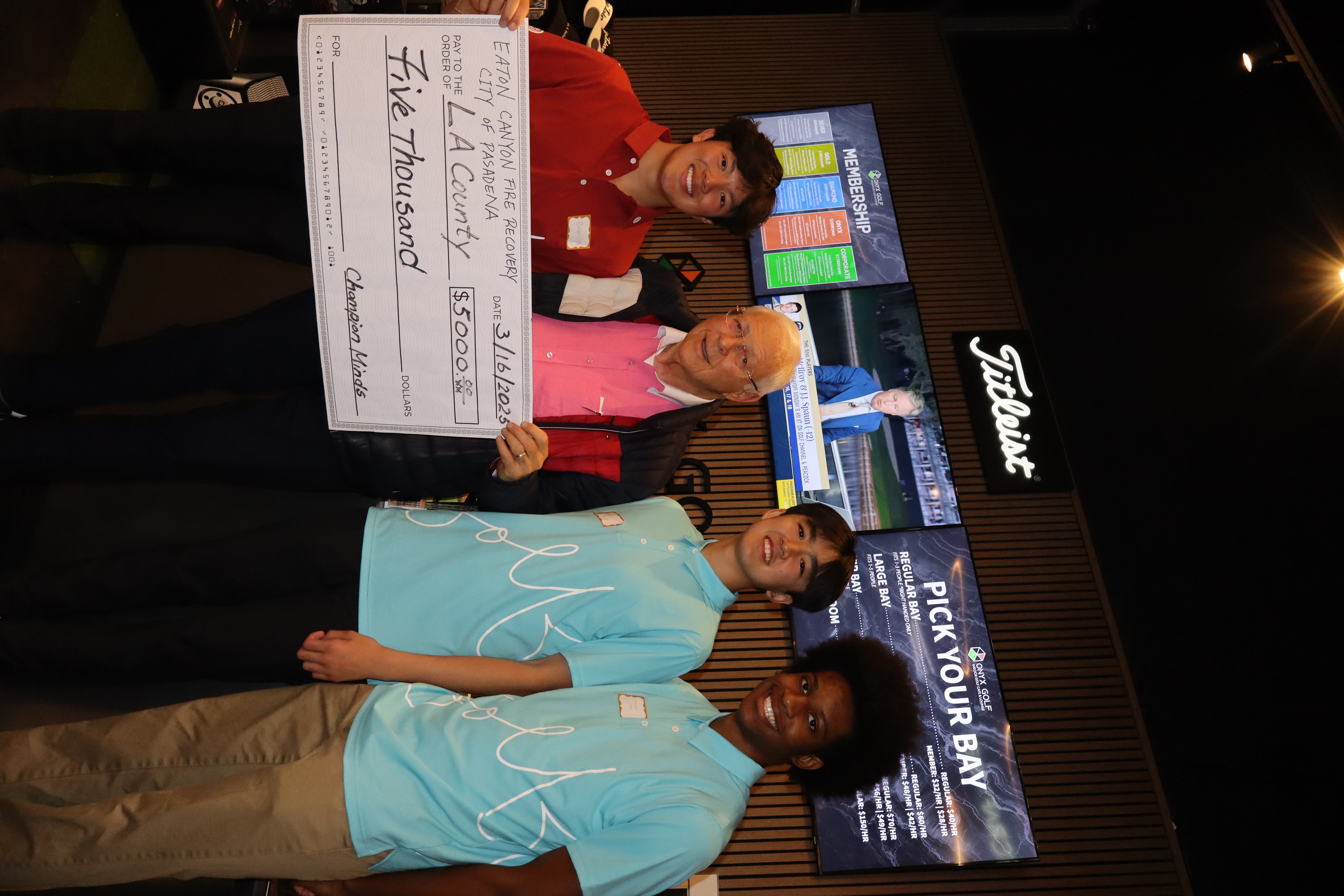 Brandon presenting a $5,000 check for Eaton Canyon fire recovery
