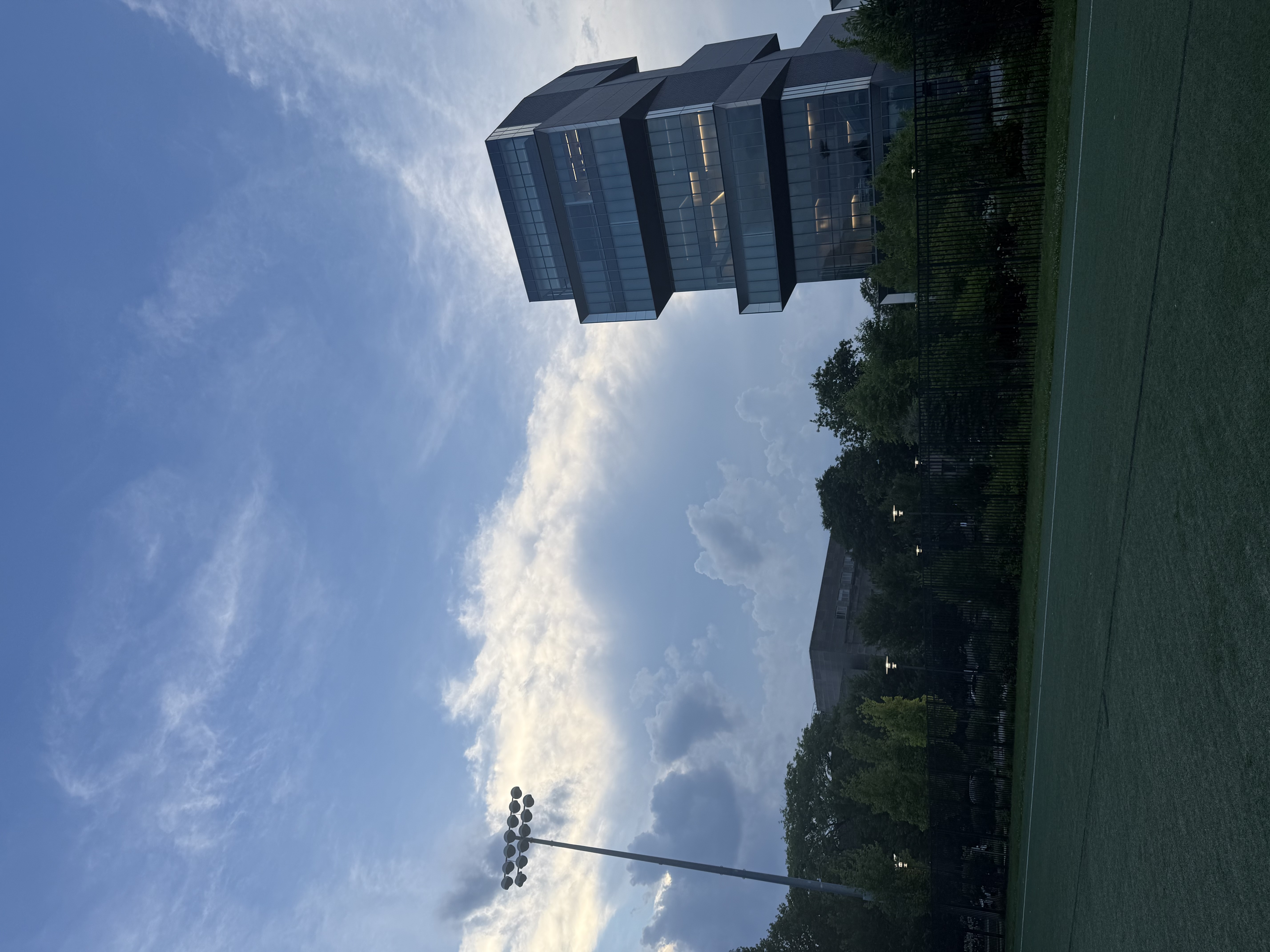 A modern glass tower at dusk near Woodlawn Residential Commons, University of Chicago